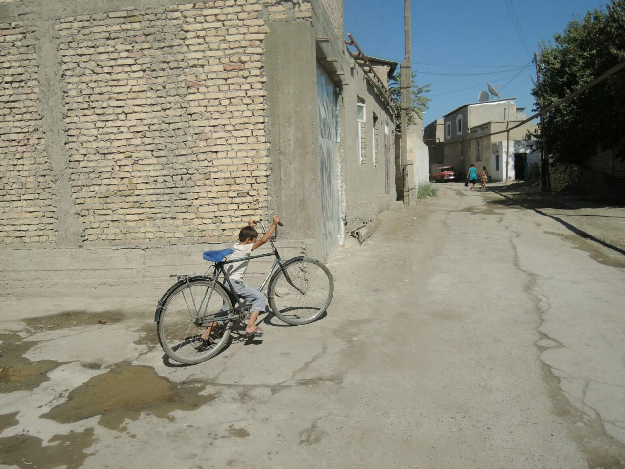 Kid with bycicle in Uzbekistan