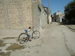 Kid with bycicle in Uzbekistan